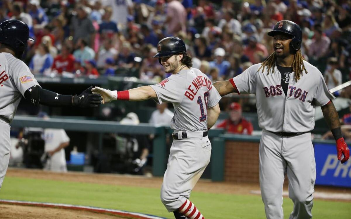 Andrew Benintendi, center, is congratulated by teammates Jackie Bradley Jr., left, and Hanley Ramirez, right, on his three-run home run against Rangers in the fifth inning Tuesday night. Benintendi also homered in the eighth and went 5 for 5 with six RBIs as the Red Sox beat the Rangers 11-4 at Globe Life Park.