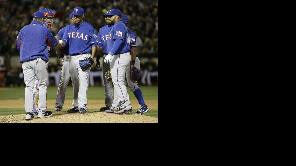 
Yovani Gallardo, center, lasted only four-plus innings in his Rangers debut as he gave up four runs and threw only 51 of his 89 pitches for strikes.


