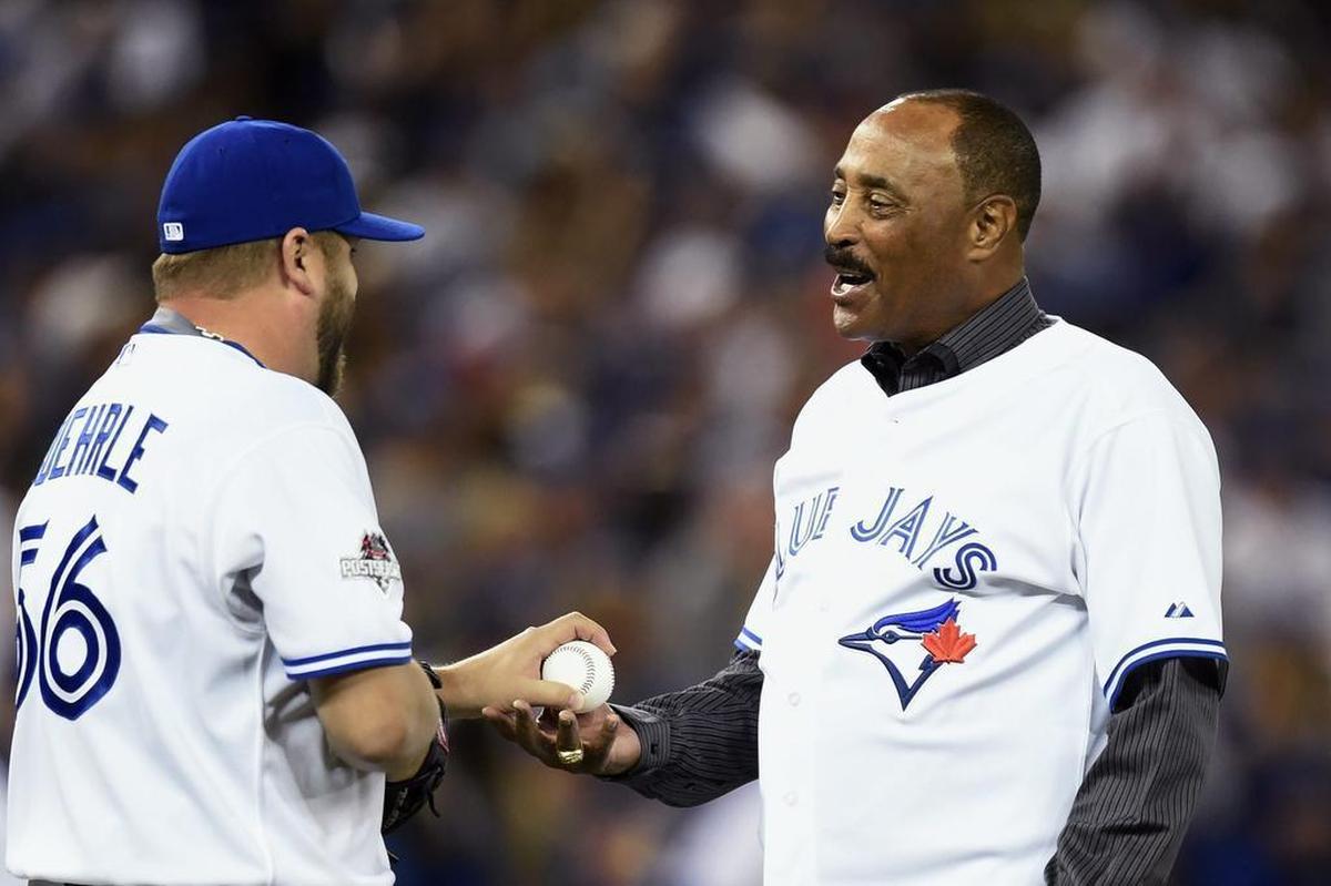 Former Toronto Blue Jays’ manager Cito Gaston, right, is greeted by Mark Buehrle after throwing out the ceremonial first pitch against the Rangers before Game 1 Thursday. One of his former pitchers Pat Hentgen had the honor before Game 2.