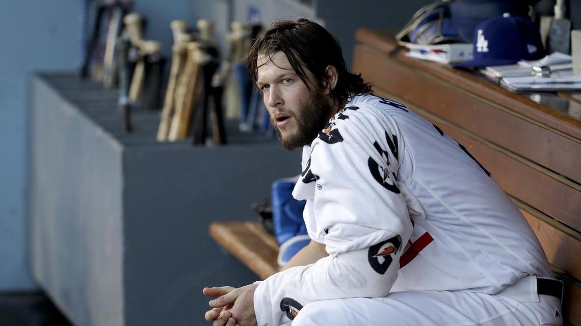Los Angeles Dodgers starting pitcher Clayton Kershaw sits in the dugout during the first inning of Game 1 of the World Series. The temperature reached as high as 103 degrees during the game in Los Angeles.