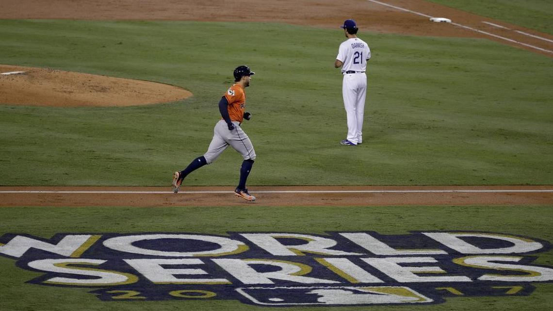 The Astros’ George Springer, left, rounds the bases after his two-run home run off Los Angeles Dodgers starting pitcher Yu Darvish in the second inning of Game 7 of the World Series Wednesday night. It was the last pitch Darvish threw in the series.