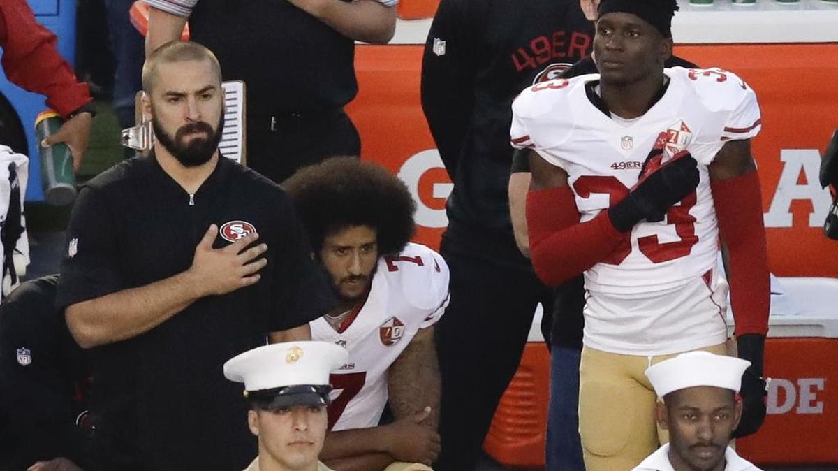San Francisco 49ers quarterback Colin Kaepernick, middle, kneels during the national anthem before the team’s NFL preseason football game against the San Diego Chargers. Kaepernick and the 49ers face the Los Angeles Rams at 9:15 p.m. Monday on ESPN.