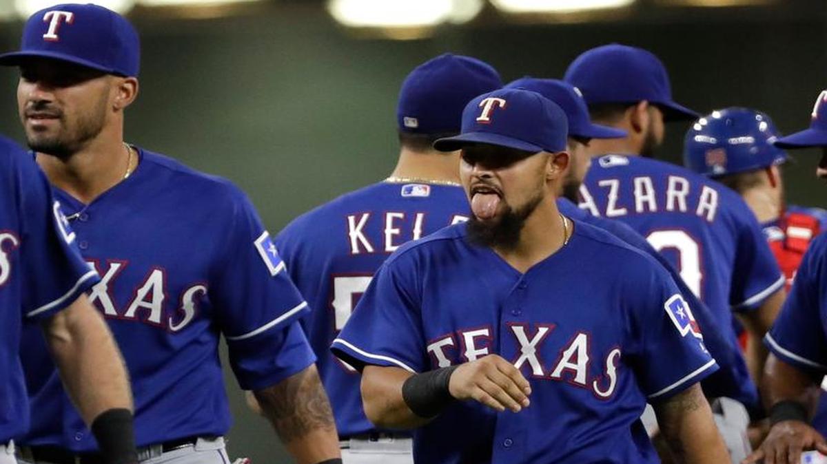 Second baseman Rougned Odor, center, celebrates with teammates after his home run in the 12th inning Monday night beat the Astros 4-3 in Houston. The Rangers and Astros close out their season series with a game Wednesday night. Telecast is at 7 p.m. on FSSW.