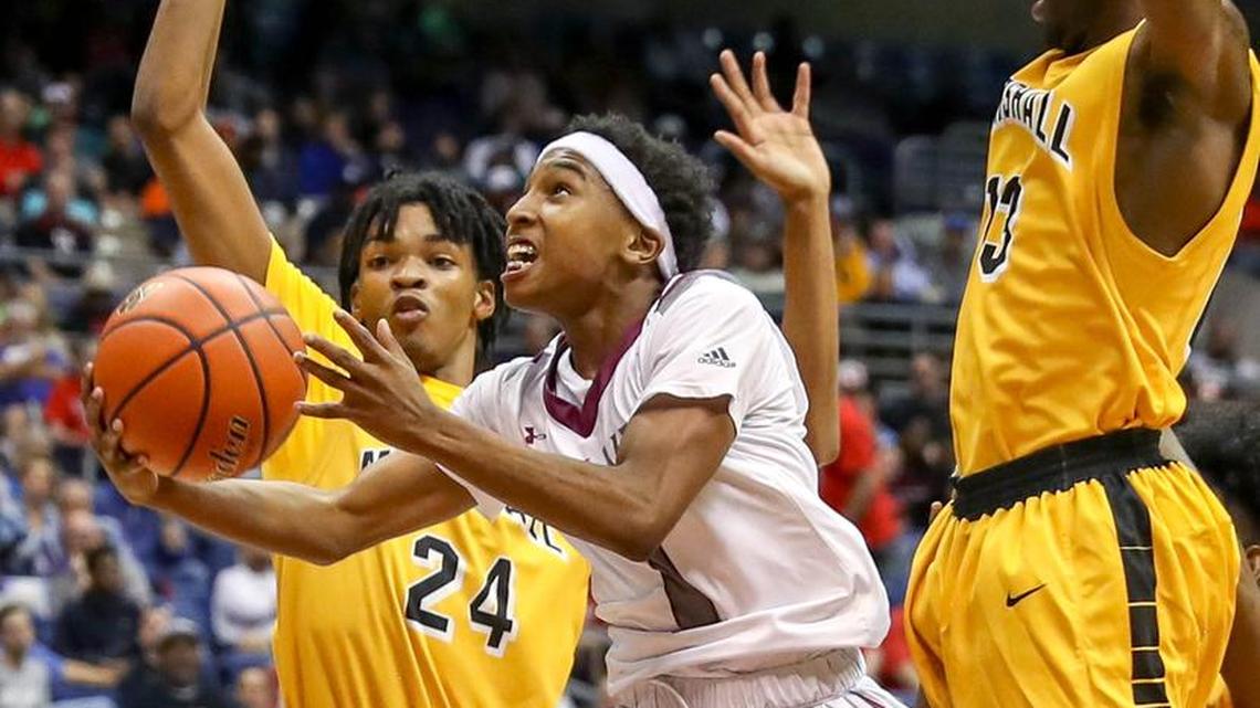 Mansfield Timberview guard CJ Smith (1) slides between Fort Bend Marshall forward Dakota Thompson, right and forward John Walker III (24) for two points during the UIL 5A Boys Basketball State Final, March 11, 2017 played at the Alamodome in San Antonio.