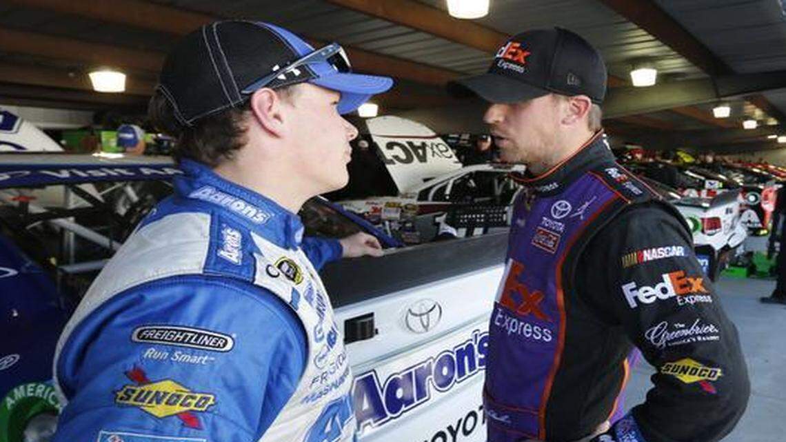 
 Denny Hamlin, right, talks with fellow driver Brett Moffitt, left, after practice for Sunday’s NASCAR Sprint Cup race. 
