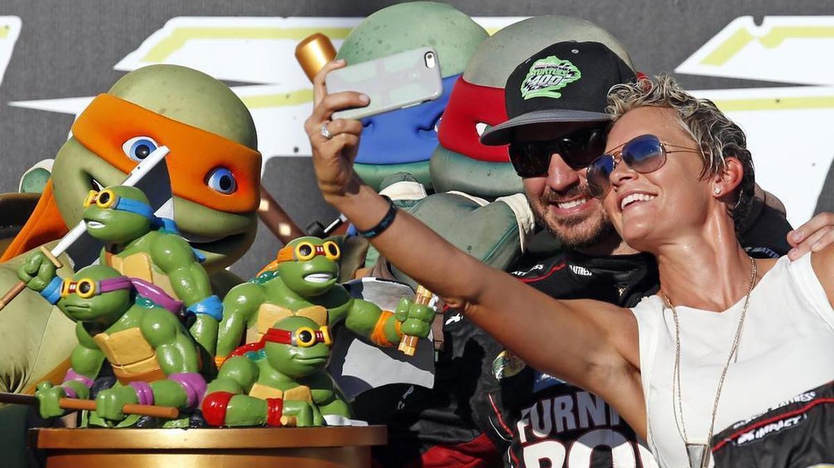 Martin Truex Jr and his girlfriend, Sherry Pollex, celebrate in Victory Lane after he won the NACAR race in Chicago in September 2016.