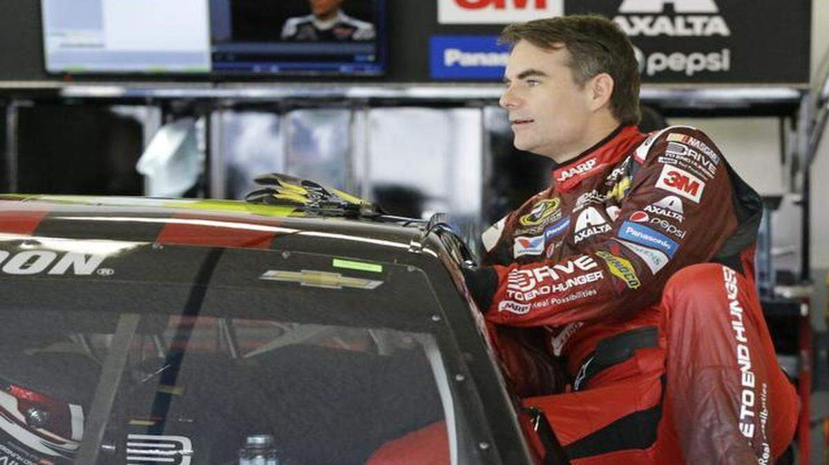 
Jeff Gordon climbs in his car to prepare for a practice for the Daytona 500 NASCAR Sprint Cup series auto race at Daytona International Speedway, Saturday, Feb. 21, 2015, in Daytona Beach, Fla. Gordon will start the Daytona 500 at the pole position. 
