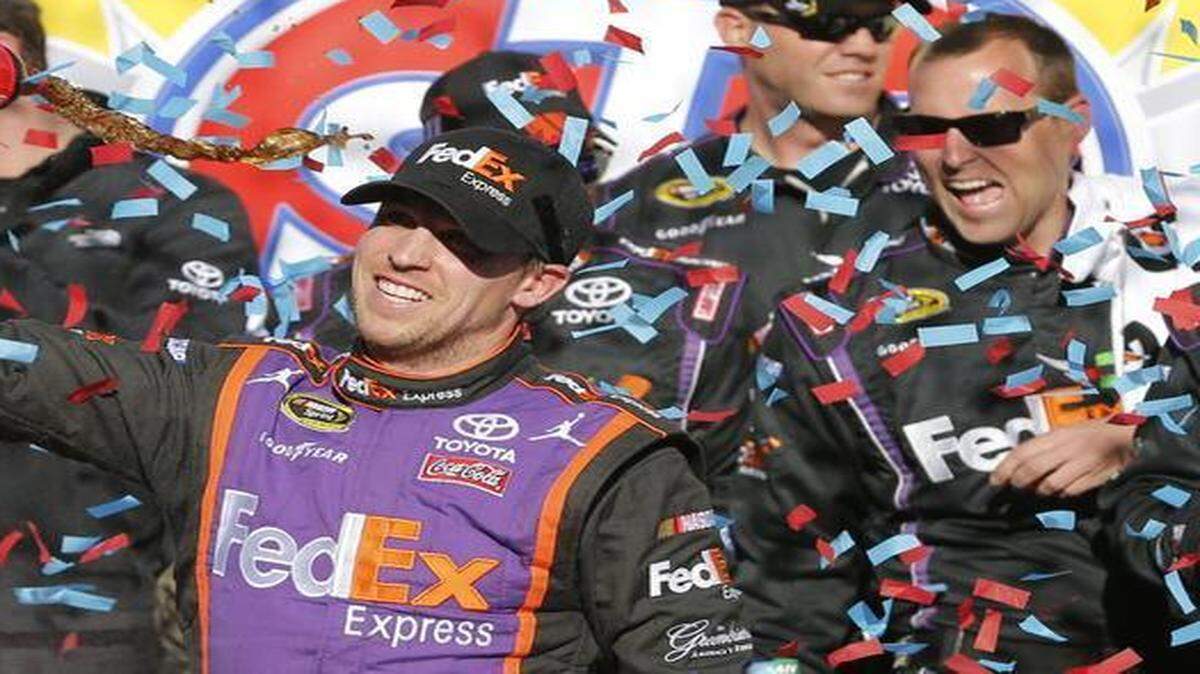 
Denny Hamlin sprays a soft drink after winning the  Sprint Cup race at Martinsville (Va.) Speedway  on Sunday. (AP Photo/Steve Helber)
