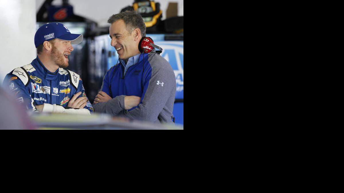 
Dale Earnhardt Jr., left, shares a laugh with a crew member Wednesday before a practice session for the Daytona 500.
