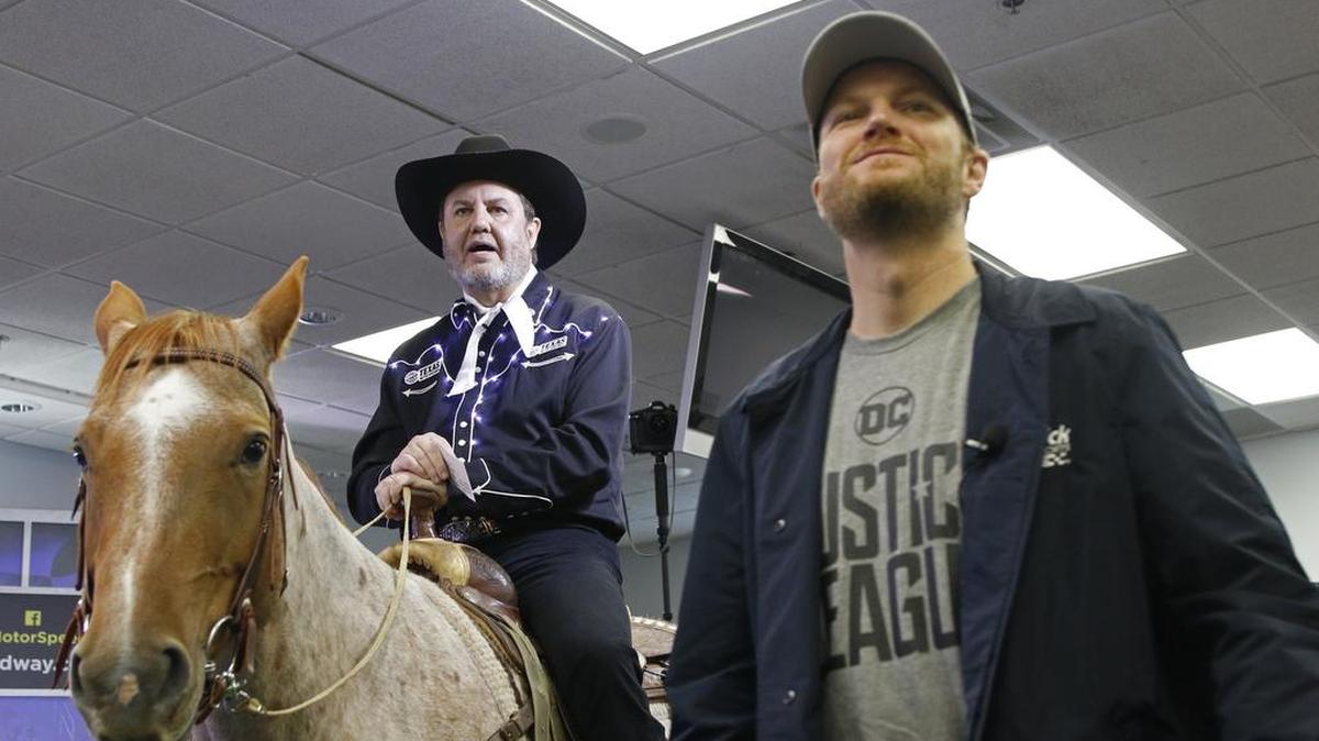 Texas Motor Speedway president Eddie Gossage, atop a thoroughbred horse, presented Dale Earnhardt Jr. with three retirement gifts on Friday, including the sponsorship of a therapy horse in Roanoke.