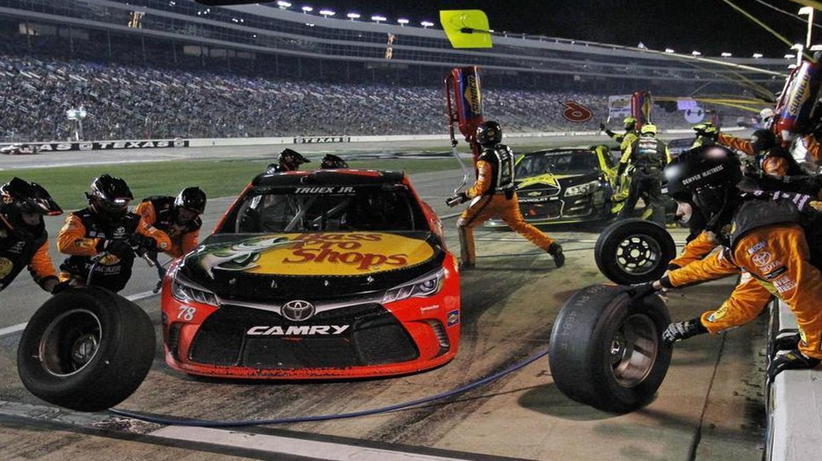 Sprint Cup Series driver Martin Truex Jr. (78) makes a pit stop on lap 177 during the running of the Duck Commander 500.