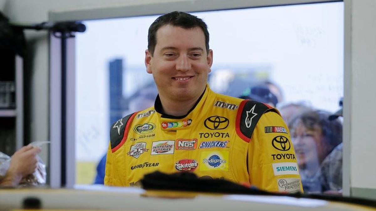 Kyle Busch smiles in the garage before practicing for the Daytona 500 at Daytona International Speedway in Daytona Beach, Fla.