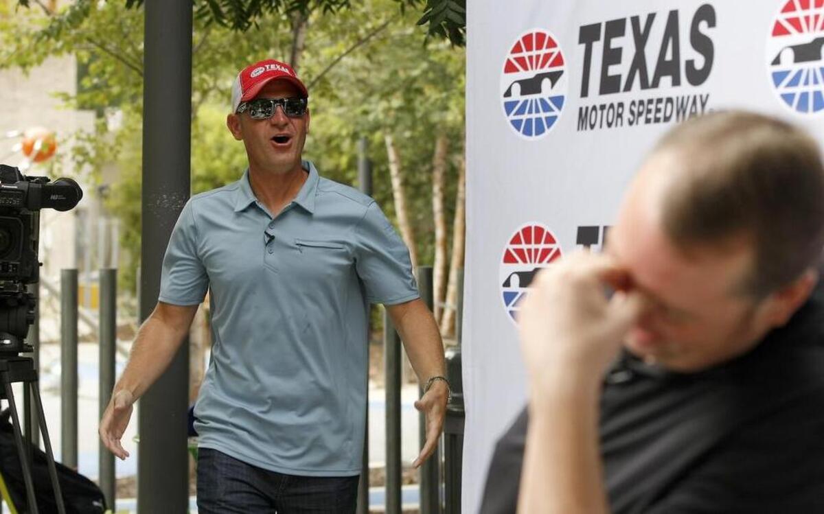 
NASCAR Sprint Cup Series driver Clint Bowyer surprises TMS season ticket holder Tom Porter of Plano Tuesday during a publicity stop in Dallas.

