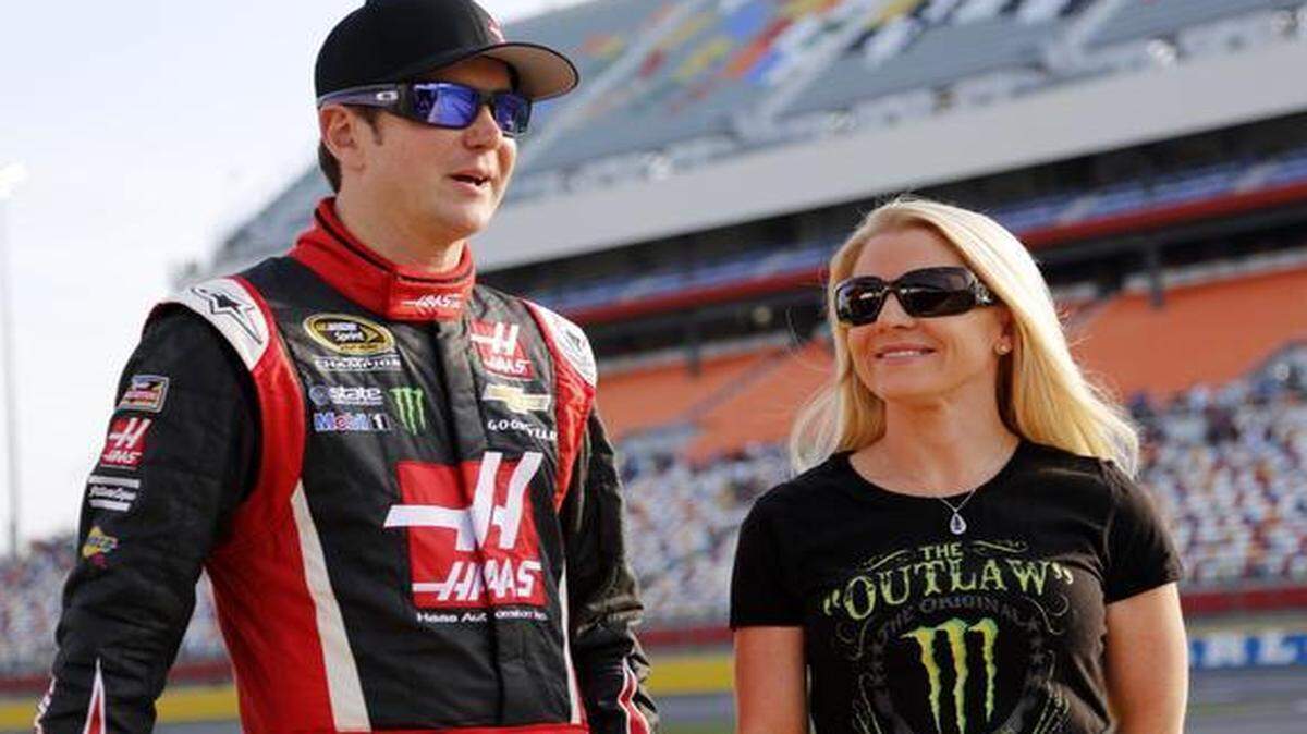 
In this May 22, 2014, file photo, Kurt Busch, left, stands with Patricia Driscoll before qualifying for a race at Charlotte Motor Speedway in Concord, N.C. NASCAR suspended Busch indefinitely on Friday, Feb. 20, 2015. 
