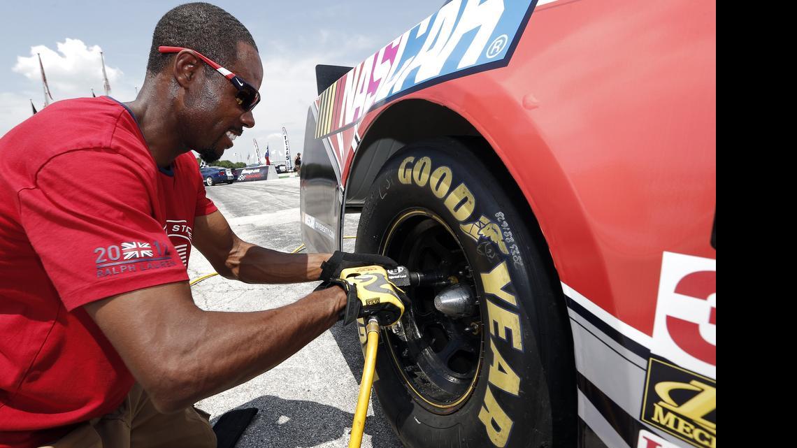Former Olympic sprinter Doc Patton demonstrates his air-gun skills during a pit crew development course during IndyCar qualifying days at Texas Motor Speedway in 2015.