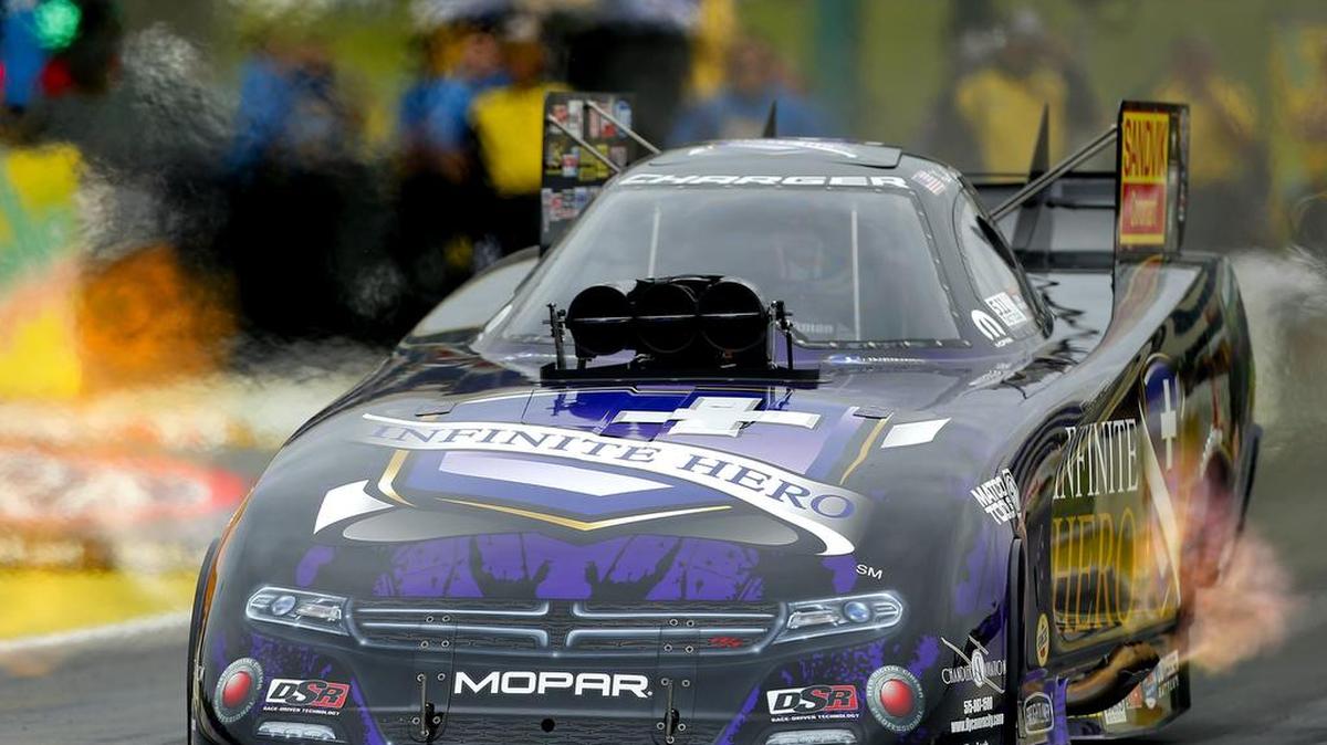
From the NHRA Kansas Nationals in May, Funny Car driver Jack Beckman accelerates down the track. Friday in Ennis, Texas, Beckman engaged in a record-setting battle with Del Worsham during qualifications at the Texas NHRA Fall Nationals. Worsham earned the provisional pole. 

