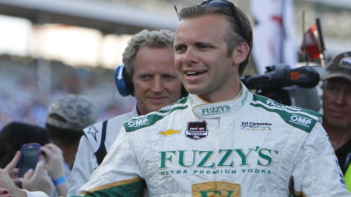 
 Ed Carpenter  slaps five with fans during driver introductions before the Verizon IndyCar Series Firestone 600 Saturday, June 7, 2014 at Texas Motor Speedway. Carpenter won the race in a non-thrilling cakewalk, the kind of racing TMS hopes won’t be repeated. 
