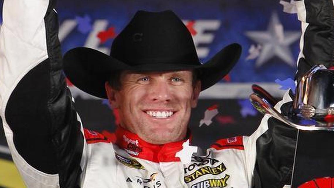 Carl Edwards fires the ceremonial pistols after winning at the AAA Texas 500 at Texas Motor Speedway.