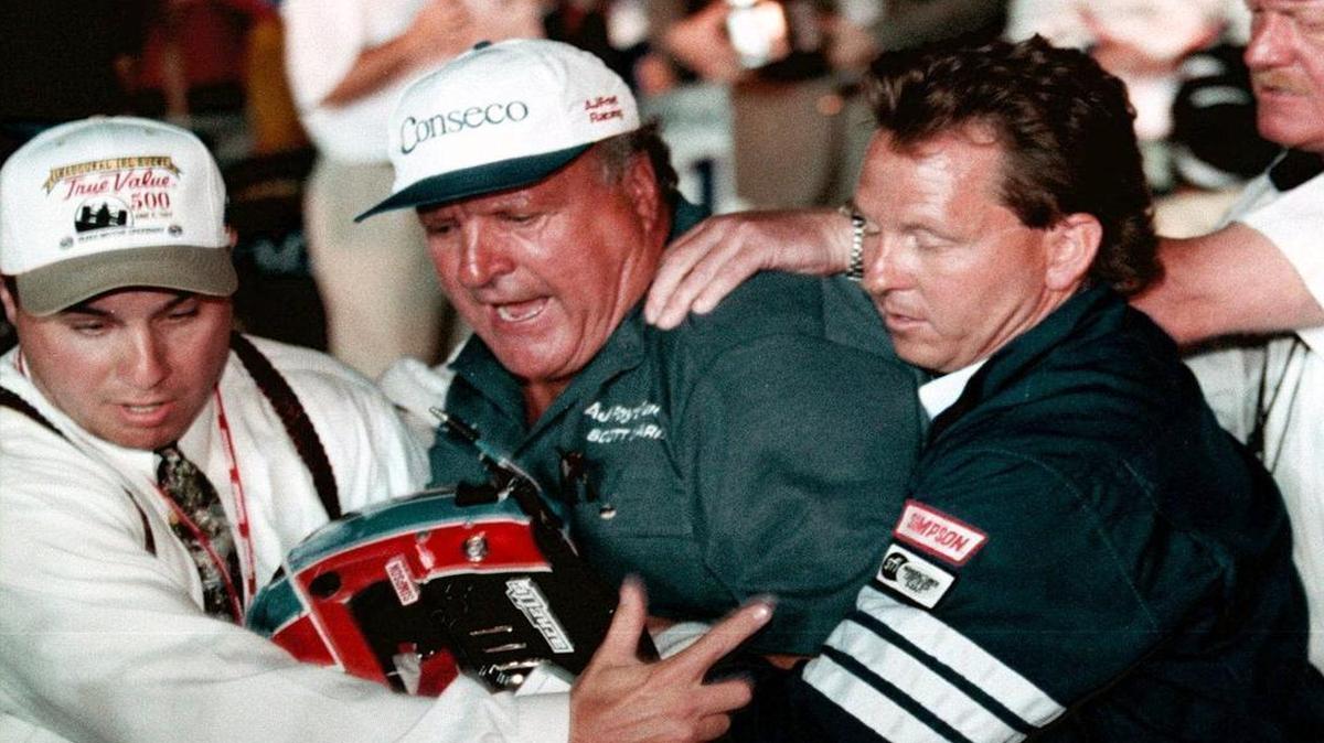 Texas Motor Speedway personnel pull A.J. Foyt, center, away from driver Arie Luyendyk in Victory Lane after the conclusion of the 1997 True Value 500. Luyendyk finished third, but complained that he deserved the victory because of a scorer’s error. He tried charging into Victory Lane and was knocked down by Foyt.