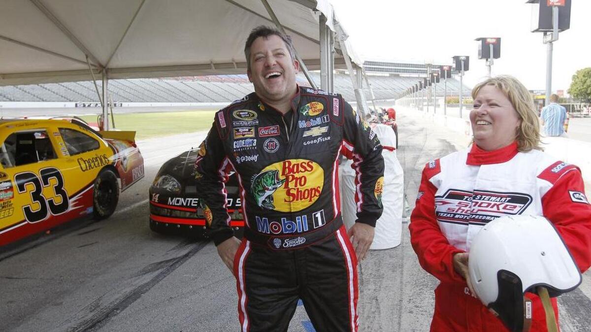 
Tony Stewart and Kathey Wadle share a laugh Wednesday during his fantasy driving camp at TMS.


