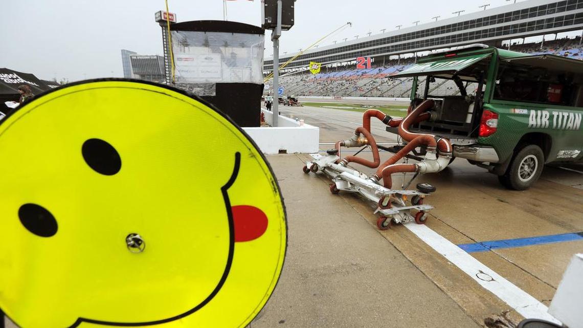 Track dryers head out in an attempt to dry the track after a rain shower moved in moments before the start of the AAA Texas 500.