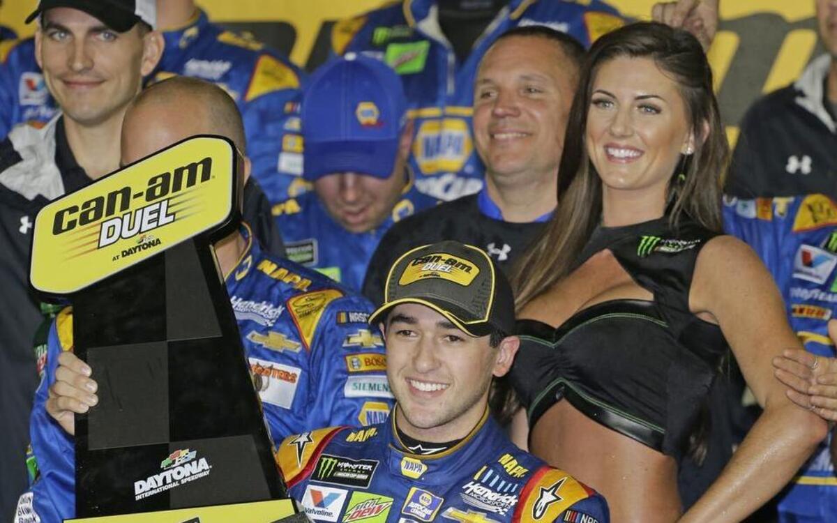 Chase Elliott celebrates after winning a qualifying race at Daytona with one of the “Monster Girls” as part of the new Monster Energy sponsorship that emphasizes glitz.