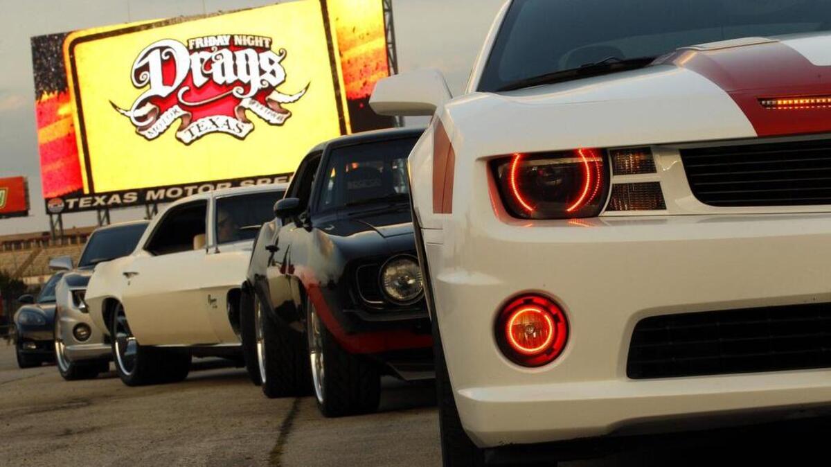 Friday Night Drags at Texas Motor Speedway includes a motorcycle and car show. Here, cars line up for the Show-N-Shine parade in 2014.