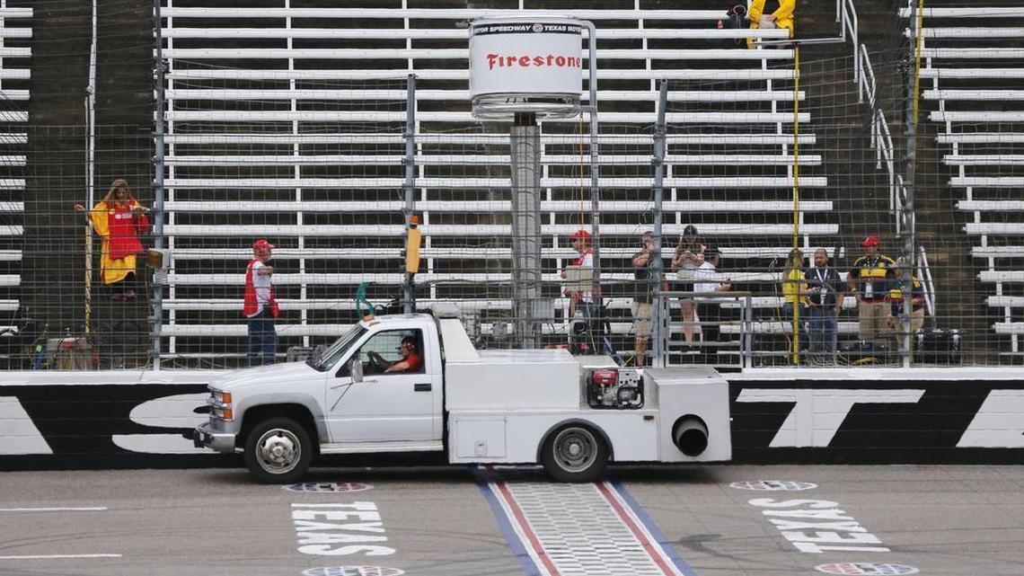 A jet dryer crosses the start/finish line on Saturday after mid-afternoon showers forced the postponement of the IndyCar Firestone 600 race. It has been scheduled to the start at 1:15 p.m. on Sunday.