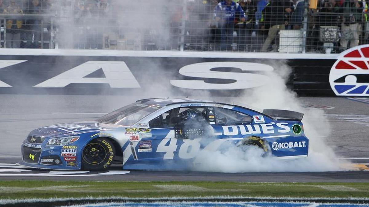Jimmie Johnson smokes the tires on the front stretch after winning the NASCAR Sprint Cup Series AAA Texas 500 at Texas Motor Speedway.