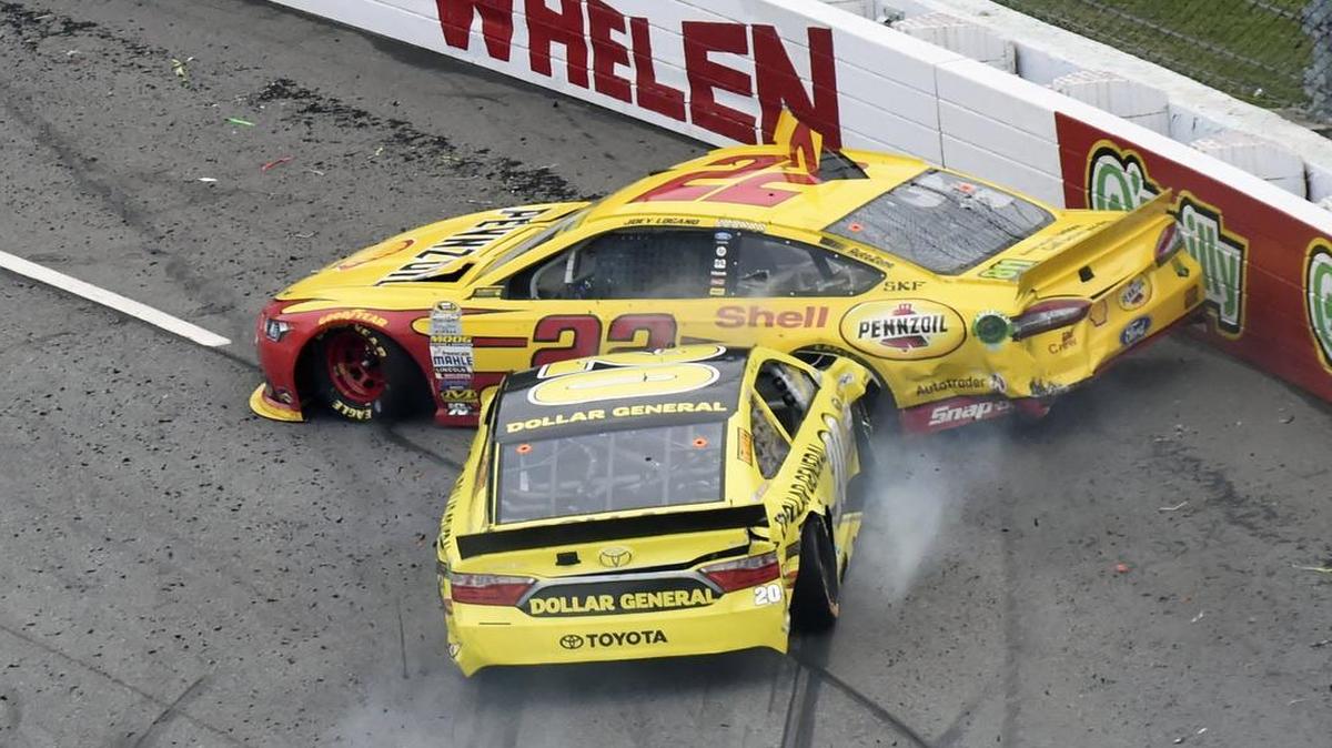 Joey Logano (22) and Matt Kenseth (20) tangle in Turn 1 during the NASCAR Sprint Cup Series auto race at Martinsville Speedway in Martinsville, Va. Kenseth was suspended for two races for the incident.