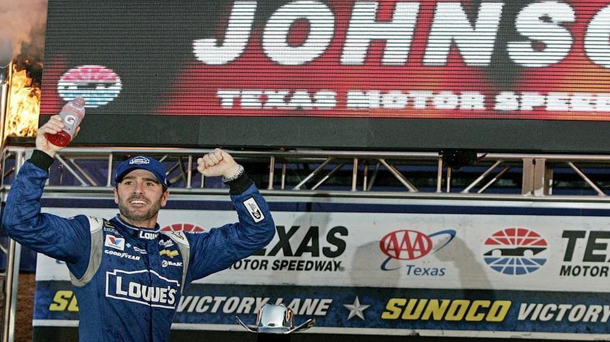 Jimmie Johnson (48) climbs out of his car to celebrate in Victory Lane after winning the 11th Annual AAA Texas 500 at Texas Motor Speedway Saturday afternoon Nov. 8, 2015. Johnson won the race for the fourth consecutive year.
