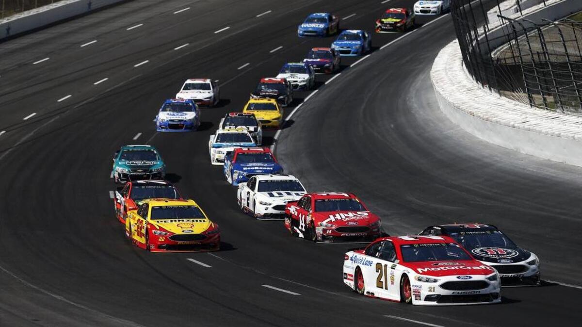 NASCAR drivers race through Turns 1 and 2 during the O’Reilly Auto Parts 500 on Sunday at Texas Motor Speedway in Fort Worth. The new surface includes lower banking and a widened track through the turns.