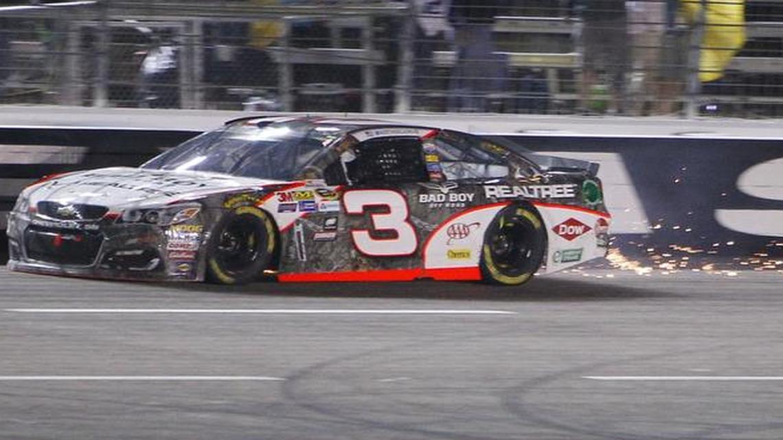 Austin Dillon's car showers sparks after hitting the wall in the front stretch after colliding with Kevin Harvick late in the the AAA Texas 500 at Texas Motor Speedway.