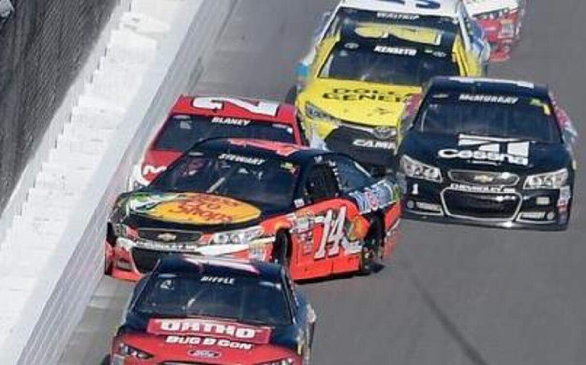 
Tony Stewart (14) hits the wall with Ryan Blaney (21) on the front stretch during the Daytona 500  on Sunday in Daytona Beach, Fla. 
