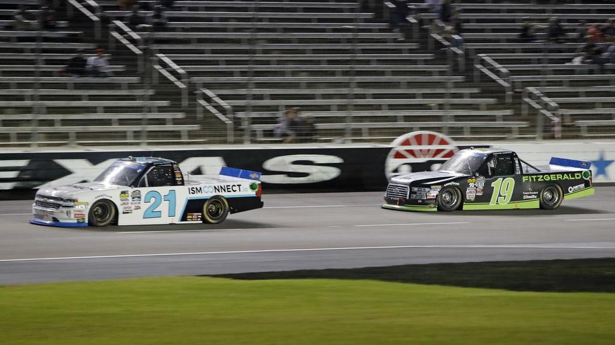 With five laps remaining, Johnny Sauter (21) leads Austin Cindric (19) down the front stretch during Friday’s Nascar Camping World Truck Series at Texas Motor Speedway. Sauter and Cindric finished 1-2.