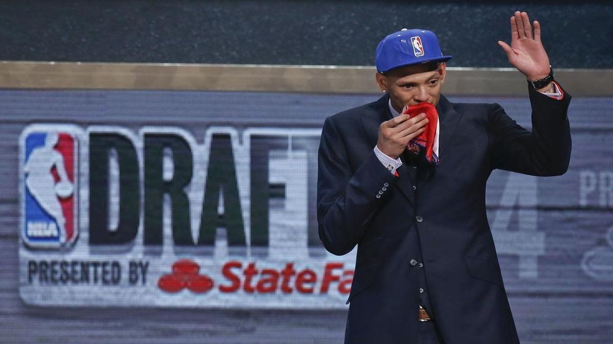 Baylor center Isaiah Austin waves to the crowd after being granted a ceremonial first-round pick during the 2014 NBA draft, Thursday, June 26, 2014. Austin, who was projected to be a first round selection was diagnosed with Marfan syndrome just four days before the draft.