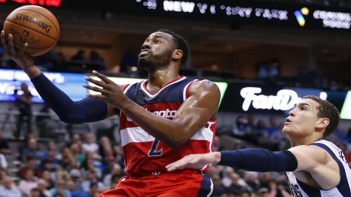 Dwight Powell, right, and the Mavericks couldn’t keep up with the Wizards’ John Wall, who had 26 points and 16 assists Saturday.