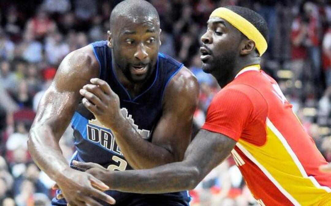 Dallas Mavericks’ Raymond Felton (2) passes the ball around Houston Rockets’ Ty Lawson in the first half of an NBA basketball game Saturday, Nov. 14, 2015, in Houston.