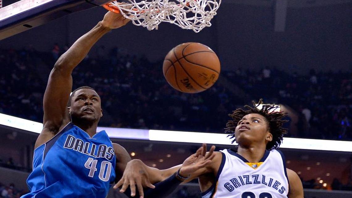 Dallas Mavericks forward Harrison Barnes, left, scores against Memphis Grizzlies forward Deyonta Davis (23) in the first half of an NBA basketball game Friday in Memphis, Tenn.