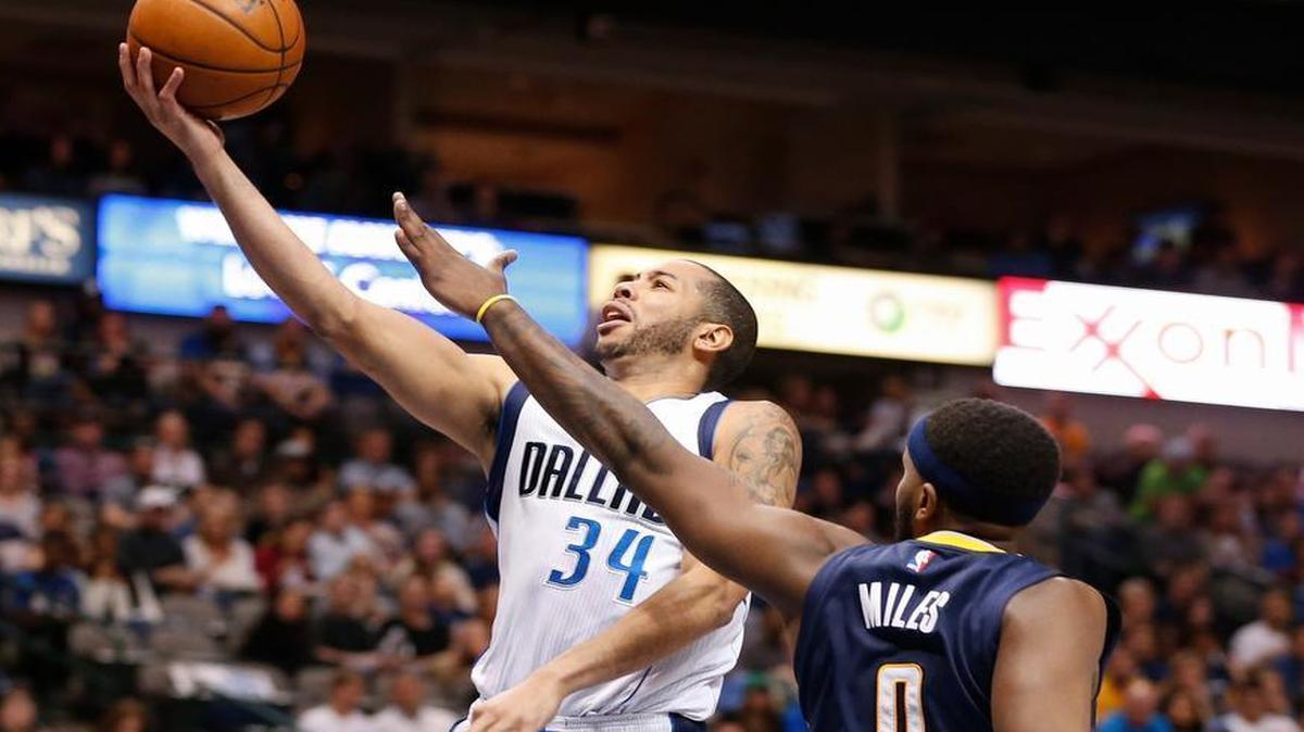 Dallas Mavericks guard Devin Harris (34) shoots over Indiana Pacers forward C.J. Miles (0) during the first half of an NBA basketball game, Saturday, March 12, 2016, in Dallas.