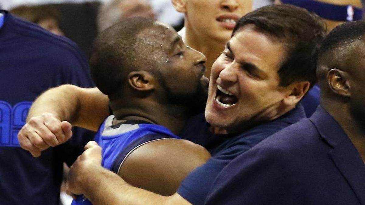 Dallas guard Raymond Felton and owner Mark Cuban hug after the Mavericks beat Oklahoma City Monday night in Game 2 of their playoff series.