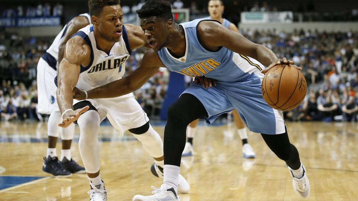 
Dallas Mavericks rookie guard Justin Anderson, left, defends Denver Nuggets rookie guard Emmanuel Mudiay, who attended Arlington Grace Prep, during Tuesday’s NBA preseason game.
