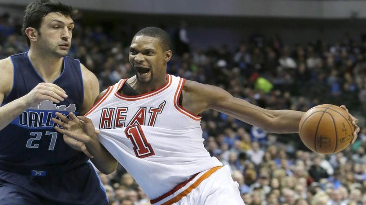 Miami Heat forward and Dallas native Chris Bosh, right, led Miami with 20 points as the Heat won in Dallas for the fifth consecutive season. Mavs defender Zaza Pachulia had 10 points and 15 rebounds.