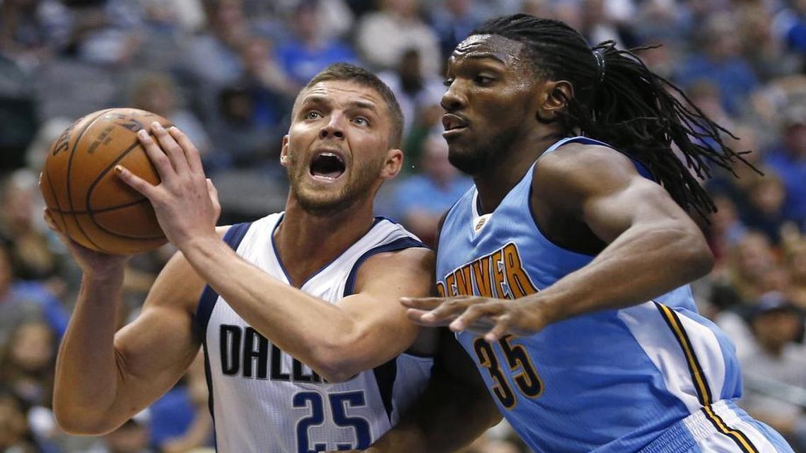 Dallas Mavericks forward Chandler Parsons (25) drives inside next to Denver Nuggets forward Kenneth Faried (35) during the second half.