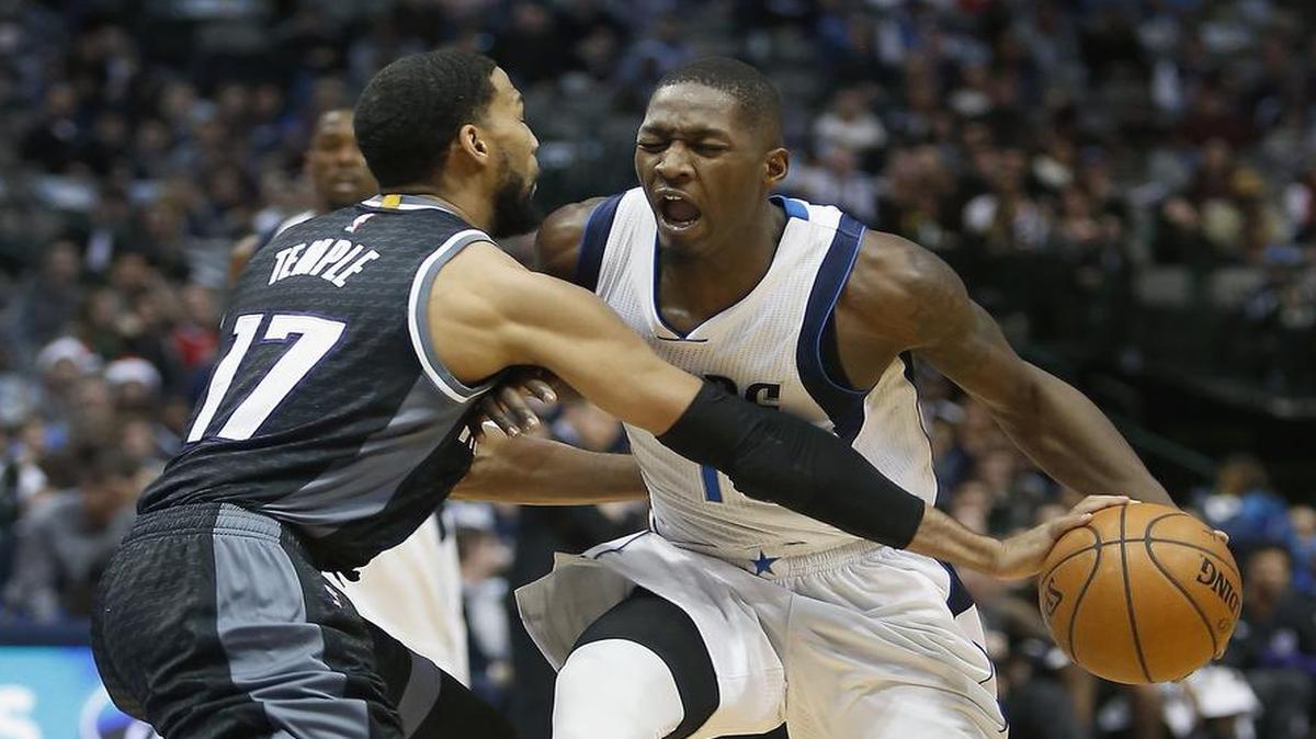 Dallas Mavericks rookie forward Dorian Finney-Smith, right, is fouled by Sacramento Kings guard Garrett Temple on Sunday. Finney-Smith scored a career-high 17 points on Sunday and will try to sustain that level when the Mavericks visit Denver for a game at 8 p.m. Monday. The telecast is on FSSW.