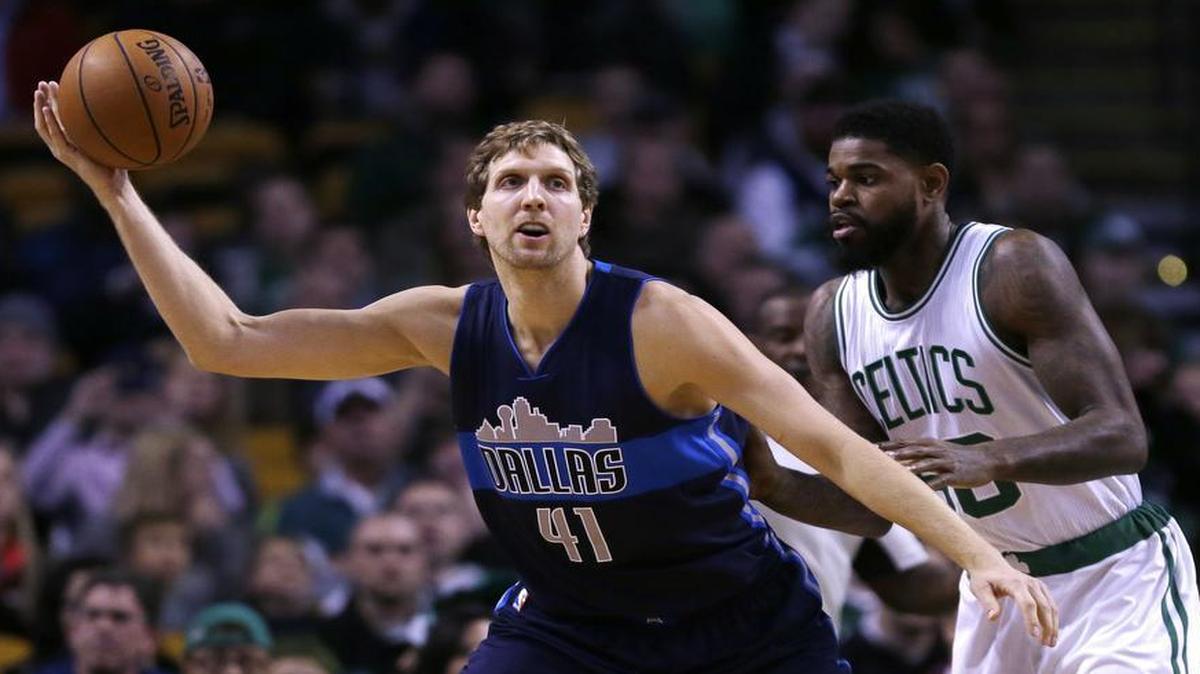 Dallas Mavericks forward Dirk Nowitzki (41) grabs a pass during the first quarter of an NBA basketball game in Boston Wednesday, Nov. 18, 2015.