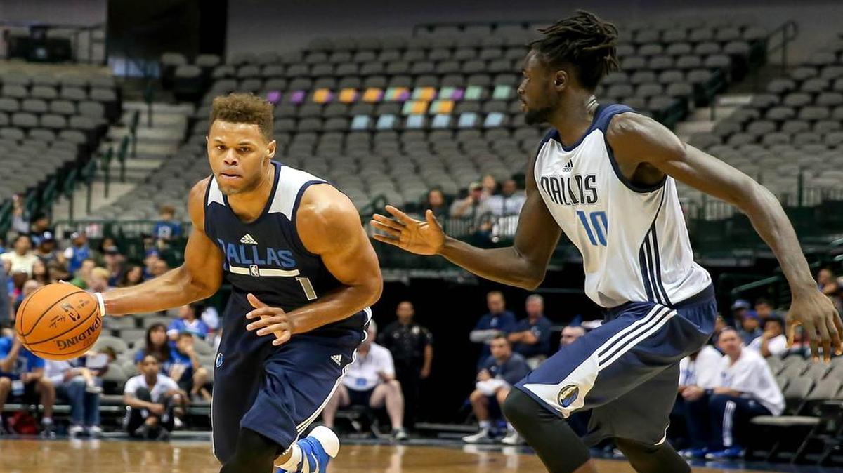 
Mavericks rookie Justin Anderson, left, tries to get around Maurice Ndour during the Blue-White scrimmage.


