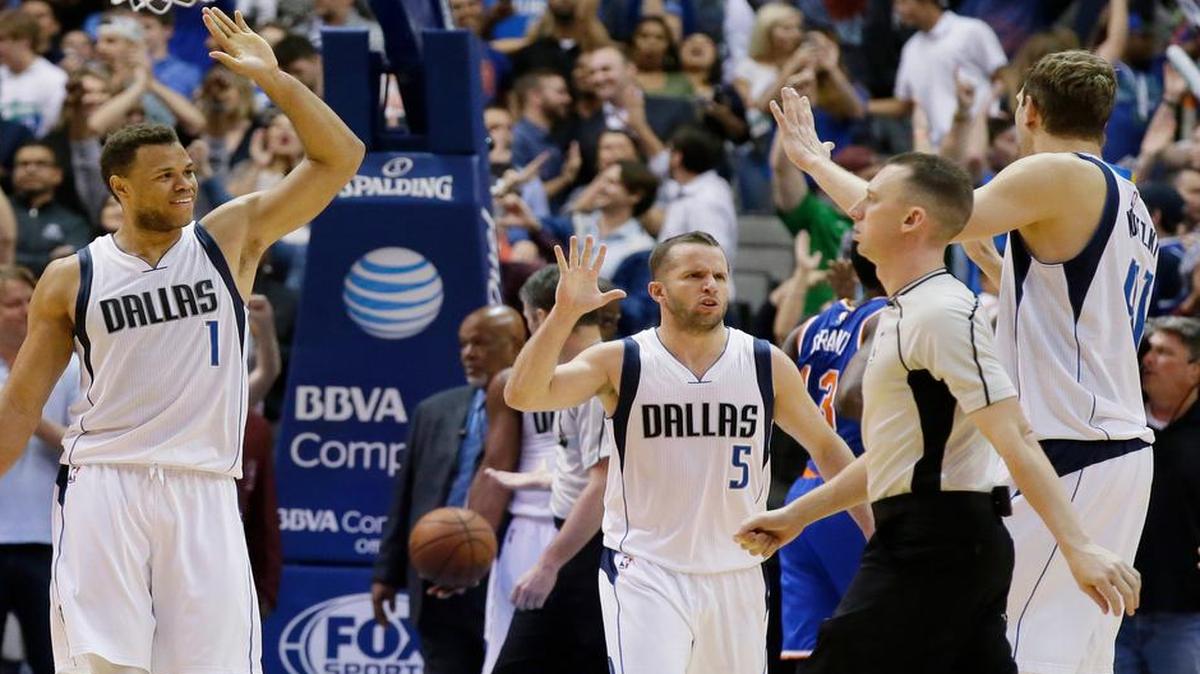 Dallas Mavericks guard Justin Anderson (1), guard J.J. Barea (5) and forward Dirk Nowitzki celebrate after an NBA win against the New York Knicks.