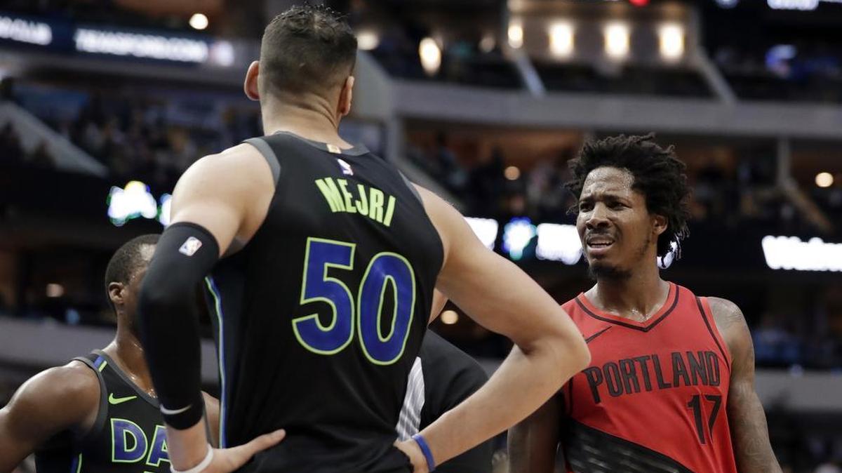 Mavericks center Salah Mejri, left, and Portland forward Ed Davis are separated after an exchange of words Friday.