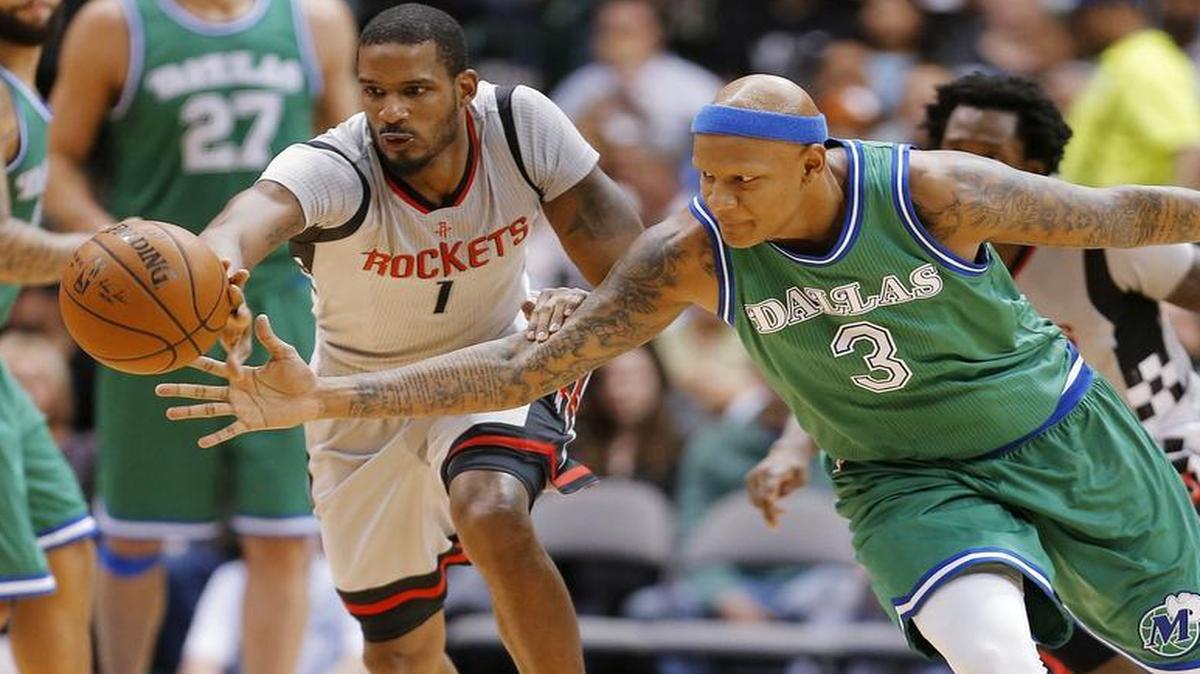 Mavericks forward Charlie Villanueva, right, and Rockets forward Trevor Ariza (1) reach for a loose ball during the first half Friday in Dallas.